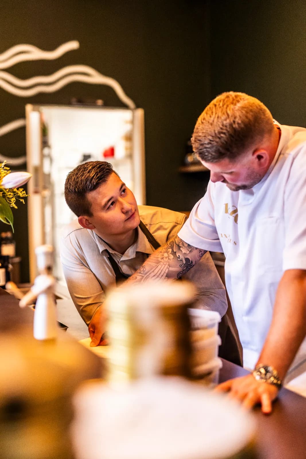 Founder Kevin Hatting in conversation with chefs in a professional kitchen